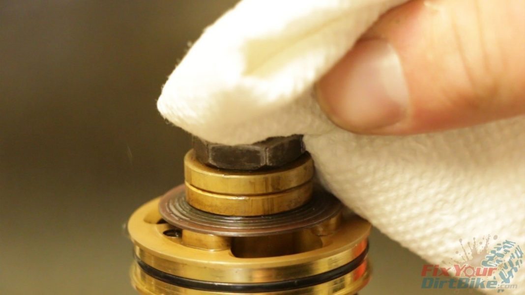 Wipe off any excess thread locker. You don't want it flaking off and clogging up your rear shock.