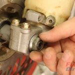 Step 2 – Loosen and remove the axle nut.