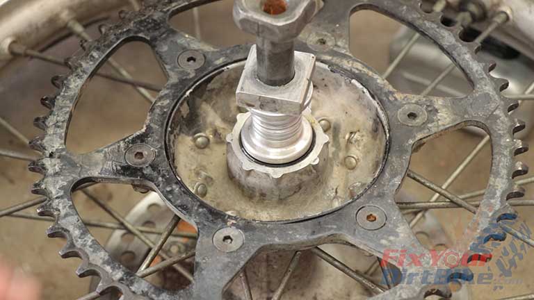 Step 20: Stack your spacers and axle block on the axle, and drop into the hub, then flip your wheel over. 