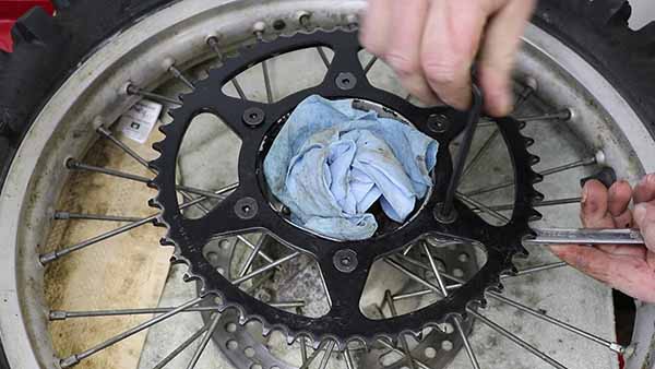 Install the sprocket hardware hand tight, then torque the rear sprocket bolts in a criss-cross pattern. Torque to 24 ft-lbs