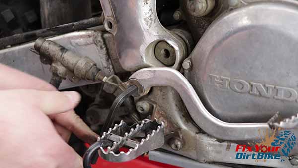 Remove the brake lever pivot bolt, then pull the entire master cylinder assembly.