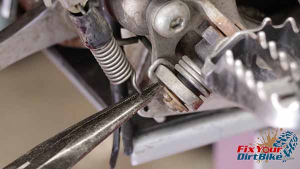 Start by disconnecting the brake pedal return spring.