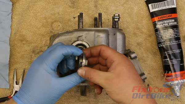 Apply grease to the valve cap threads, and install the cap hand tight.
