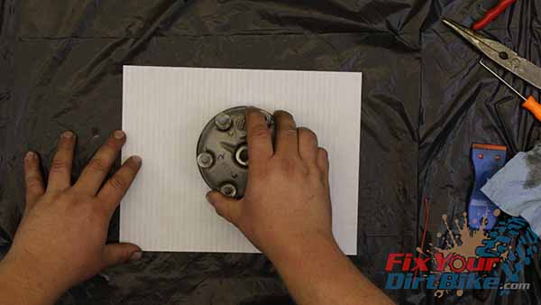 Run your cylinder head in a figure-eight motion against the paper, using light pressure.