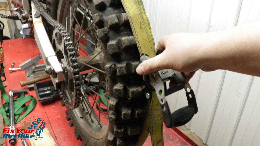 Bind The Rear Wheel With A Long Ratchet Strap