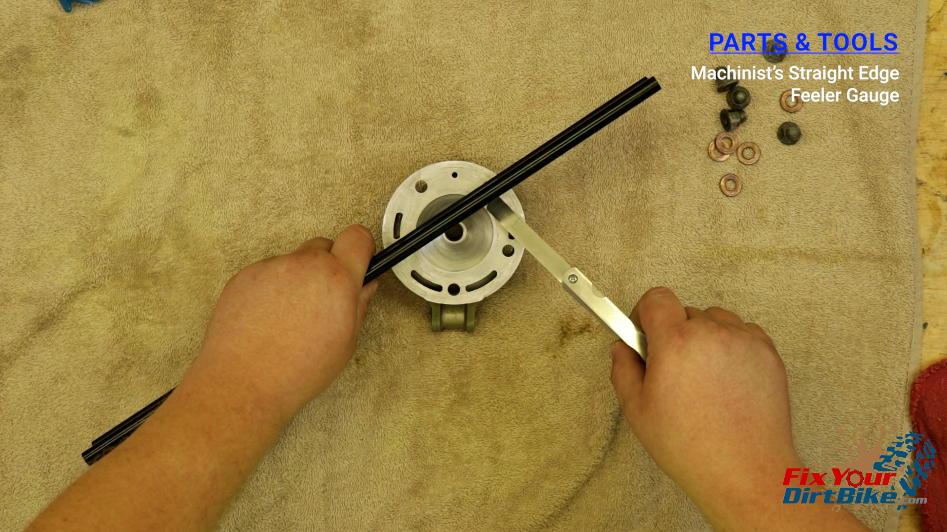 4 - Lay your straight edge across two adjacent mounting holes, and try to fit your feeler gauge underneath