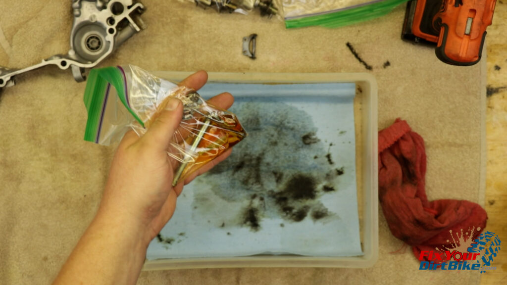 4 - Place your connecting rod assembly in a zip-lock bag and spray it down with penetrating oil to deep clean the pivot points