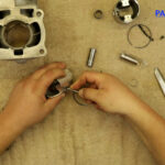 8 – Install the first piston pin clip into the pin bore groove.