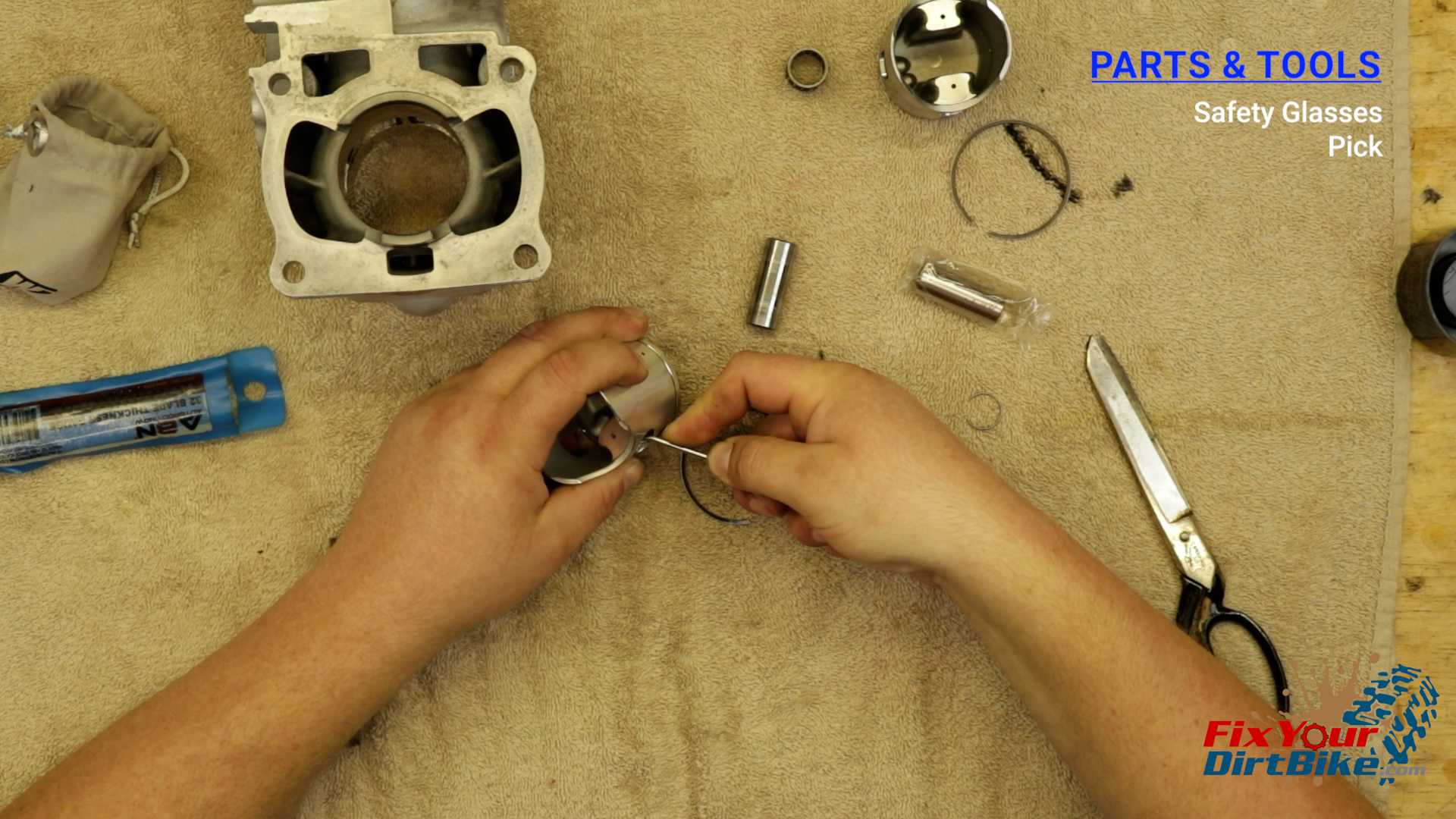 8 - Install the first piston pin clip into the pin bore groove.