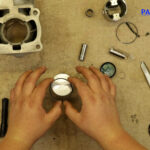 9 – Lubricate the piston edge and ring grooves with 2-stroke oil.